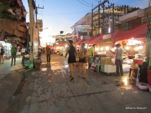 Massive row of street food stalls with an over the top tiger themed bar to the side Patong Phuket