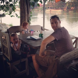 family sitting at restaurant by the river in ayutthaya