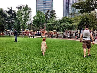 KLCC playground in the distance with kids Kuala Lumpur