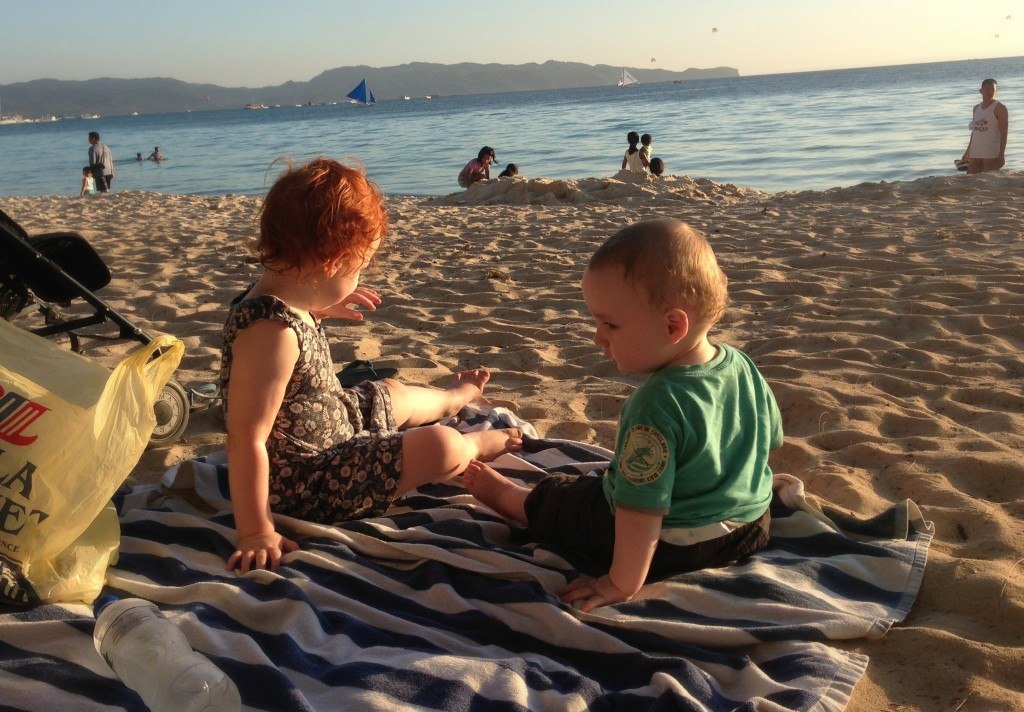 baby and toddler on white beach in Boracay