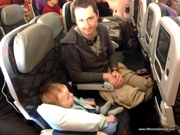 travelling with an infant on a plane sitting on a seat sleeping