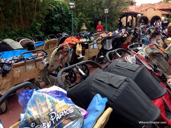 many strollers and prams in a stroller parking area in magic kingdom disneyworld