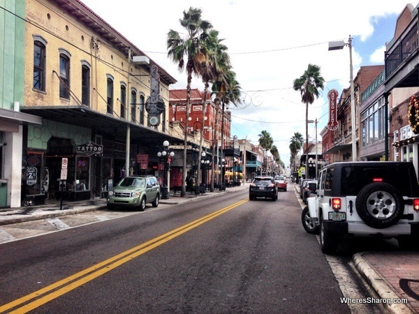 Shops, bars, cars and road in Ybor City