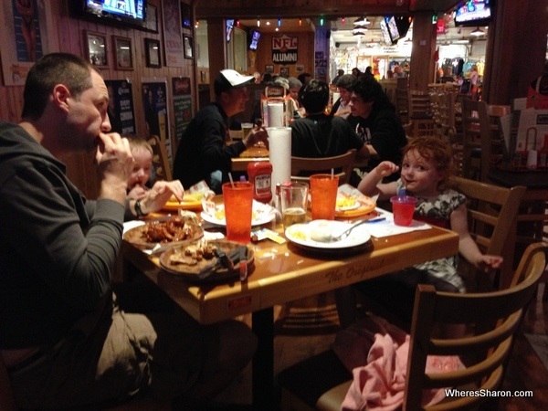 family sitting and eating food at Hooters Clearwater