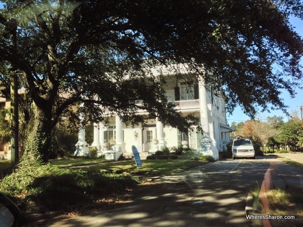 Big old white house with trees on government street mobile