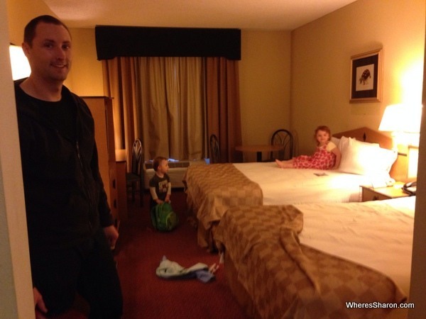 family on beds in Baymont Inn and Suites room motel chains USA