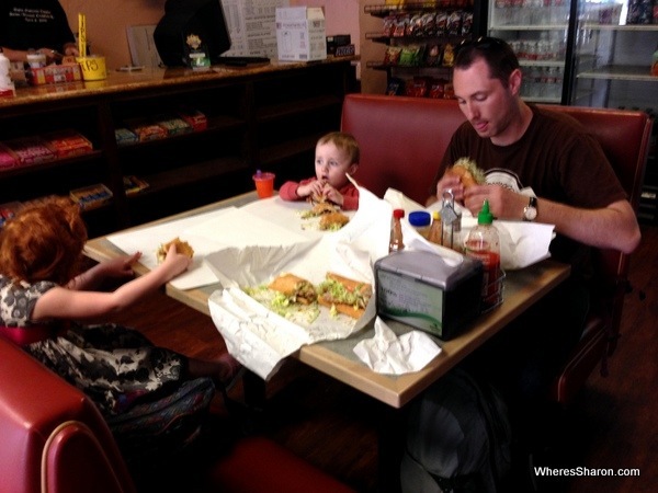 Family eating beef and chicken po-boys in new orleans