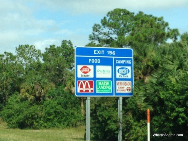 Exit sign on interstate in florida showing food options miami to new orleans drive