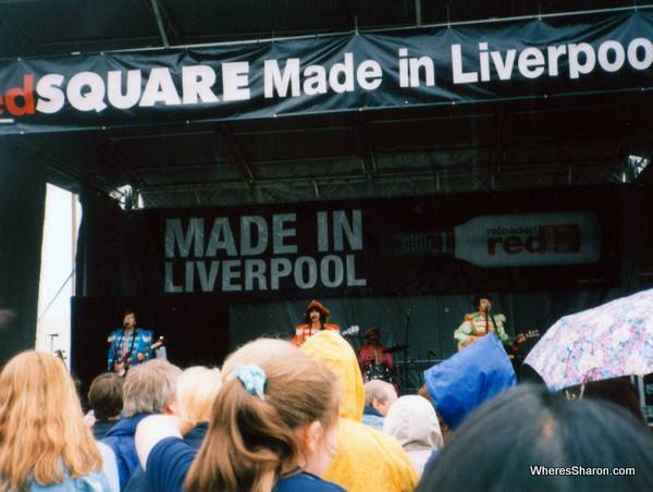 band dressed as the beatles on stage 