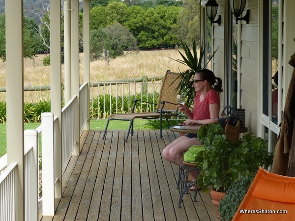 drinking wine on verandah at Airbnb Victoria farm stay