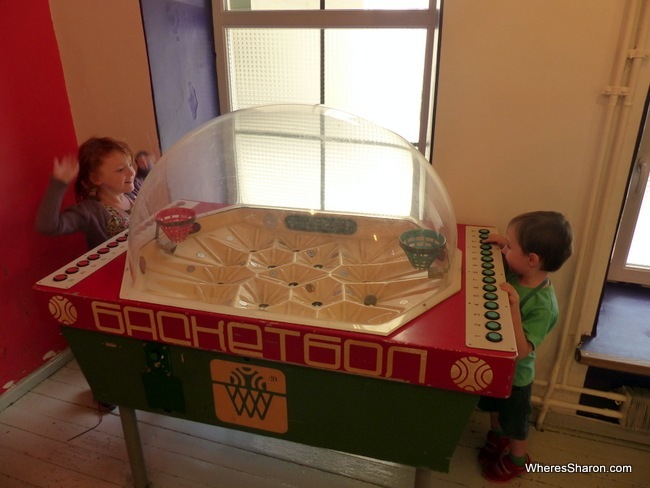 The kids playing it up, Communist style, on a basketball table.