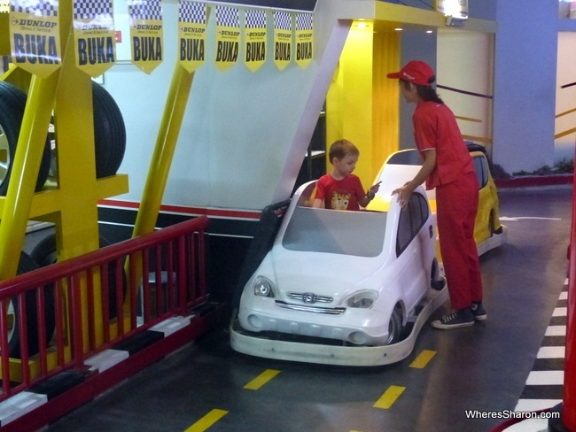 Z gets his car fuelled up at the petrol station.